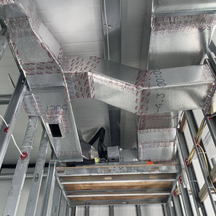 Insulated sheet metal trunk lines on a commercial new build