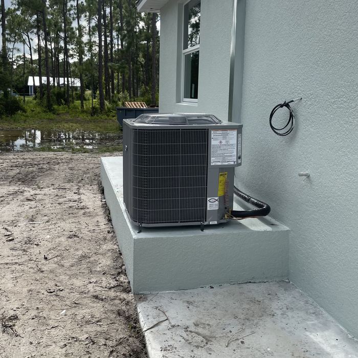 New condenser set on its pad at a new home